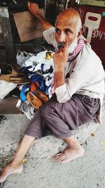 High angle portrait of a man sitting outdoors