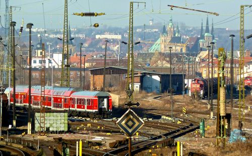 Train on railroad track with city in background