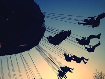 Low angle view of people at amusement park