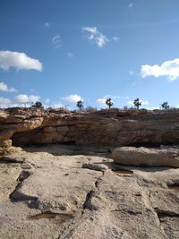 View of rocks against cloudy sky