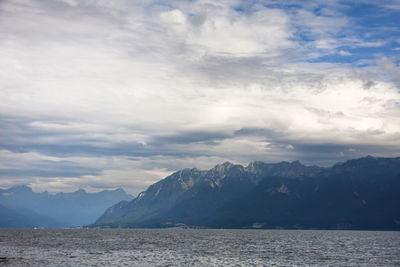 Scenic view of sea and mountains against sky