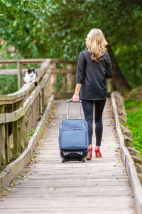 Rear view of woman walking on footpath