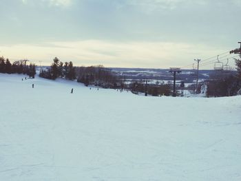 Snow covered landscape against sky