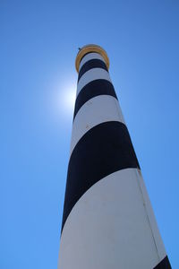 Low angle view of lighthouse against clear blue sky