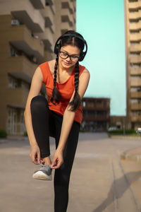 Portrait of young woman standing on road