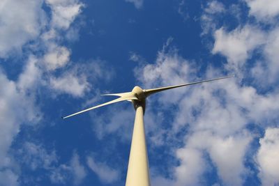 Low angle view of wind turbine against cloudy sky