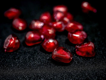 Close-up of cherries on table against black background