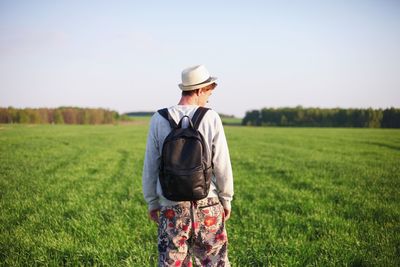 Rear view of man standing on field