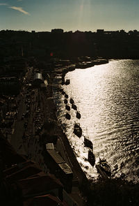 High angle view of buildings by sea against sky