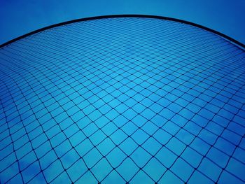 Low angle view of grid pattern against clear blue sky
