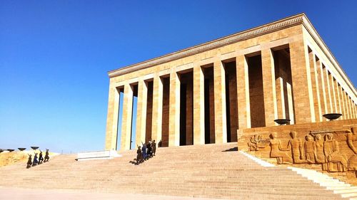 Low angle view of built structure against clear blue sky