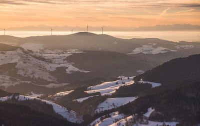 Scenic view of snowcapped mountains against sky during sunset