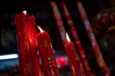 Close-up of lit candles in temple