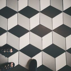 Low section of person on tiled floor