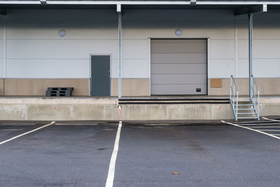 Empty parking lot by building