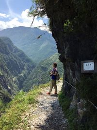 Full length of man standing on mountain against sky