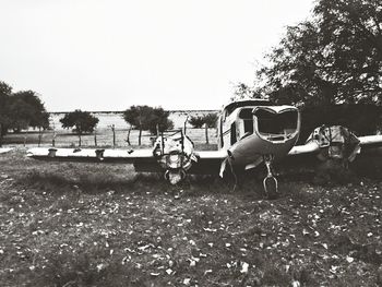 Horse cart on field against clear sky