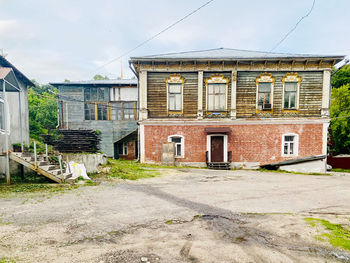 Residential buildings by street against sky