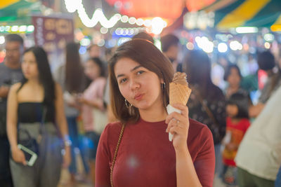 Portrait of young woman standing outdoors