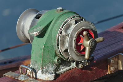 Close-up of rusty machine part against sky