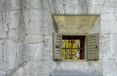 Low angle view of window on wall of building