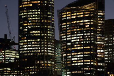 Low angle view of illuminated buildings in city at night