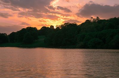 Scenic view of lake against orange sky