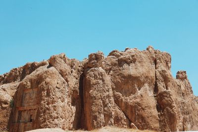 Low angle view of mountain against clear blue sky