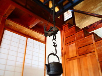 Low angle view of electric lamp hanging on ceiling