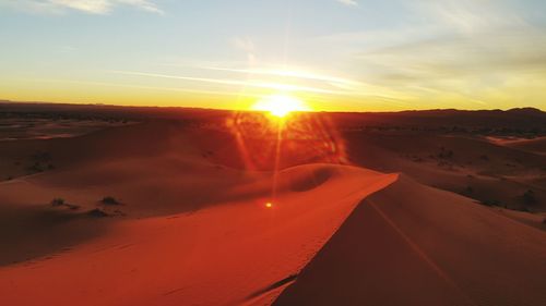 Scenic view of desert against sky during sunset