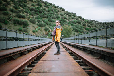 Portrait of man standing on railroad track