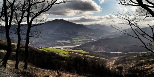 Scenic view of landscape and mountains against sky