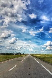 Road by landscape against sky