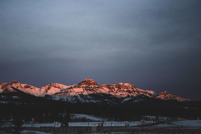 Scenic view of snowcapped mountains against sky during sunrise