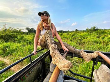 Full length of woman on jeep against sky