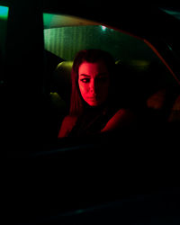 Portrait of young woman in car