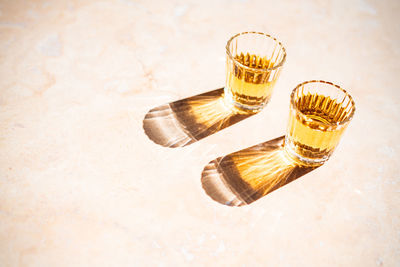 High angle view of glasses on table against white background
