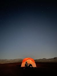 Man standing on field against sky at night