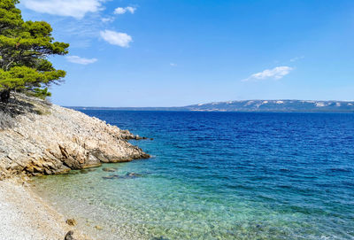 Beautiful turquoise and blue water on empty beach in amazing cove in summer.