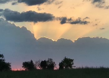 Scenic view of silhouette mountains against sky at sunset