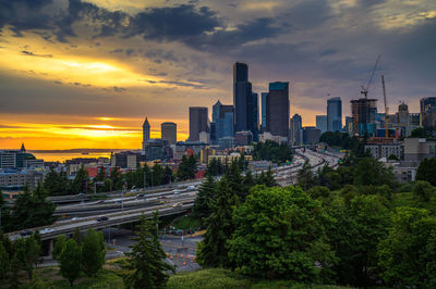 Buildings in city against sky during sunset