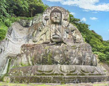 Low angle view of statue against plants