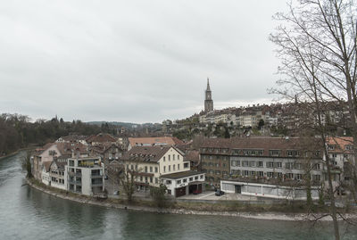 River amidst buildings against sky