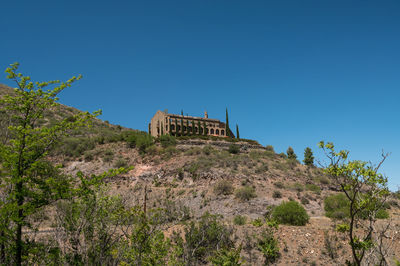 Low angle view of historical building against clear blue sky