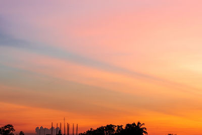 Low angle view of silhouette trees against sky during sunset