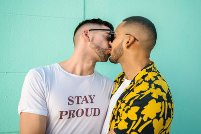 Gay couple embracing while standing outdoors