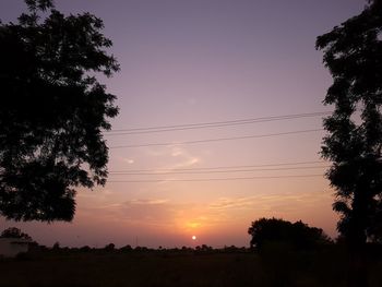 Low angle view of silhouette trees against sky during sunset