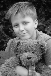 Portrait of boy with toy in park