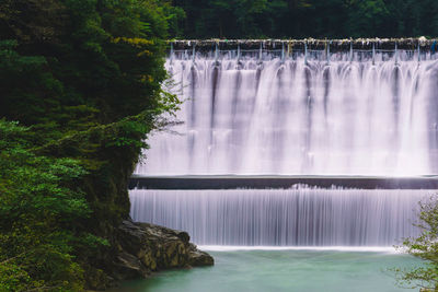 Scenic view of waterfall in forest