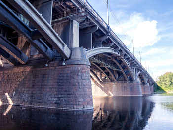 Low angle view of bridge over river against sky